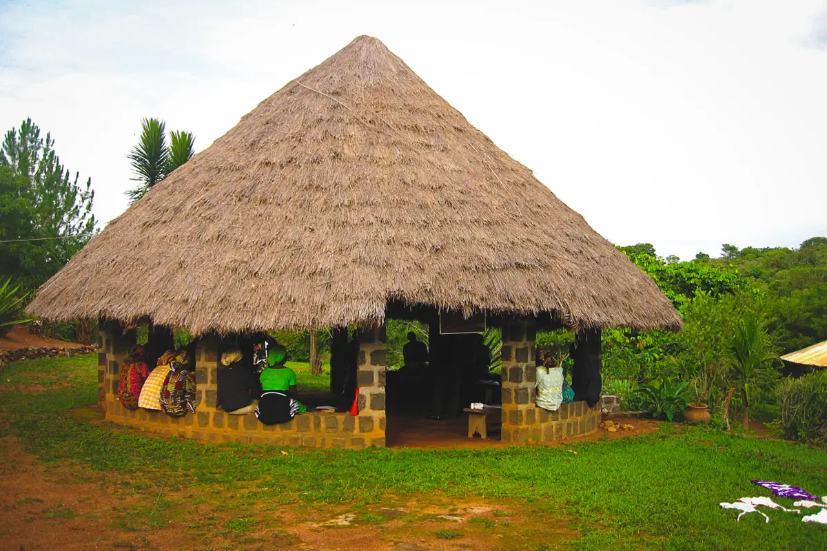 Traditional African village barray - circular thatched-roof meeting hut with wooden support posts in village setting